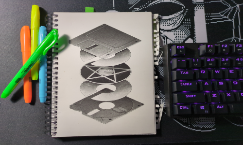 old spiral notebook with multiple color hilighters and part of a keyboard